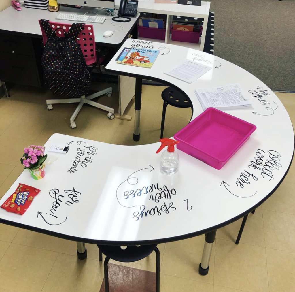 photo of desk with sub plans written on them